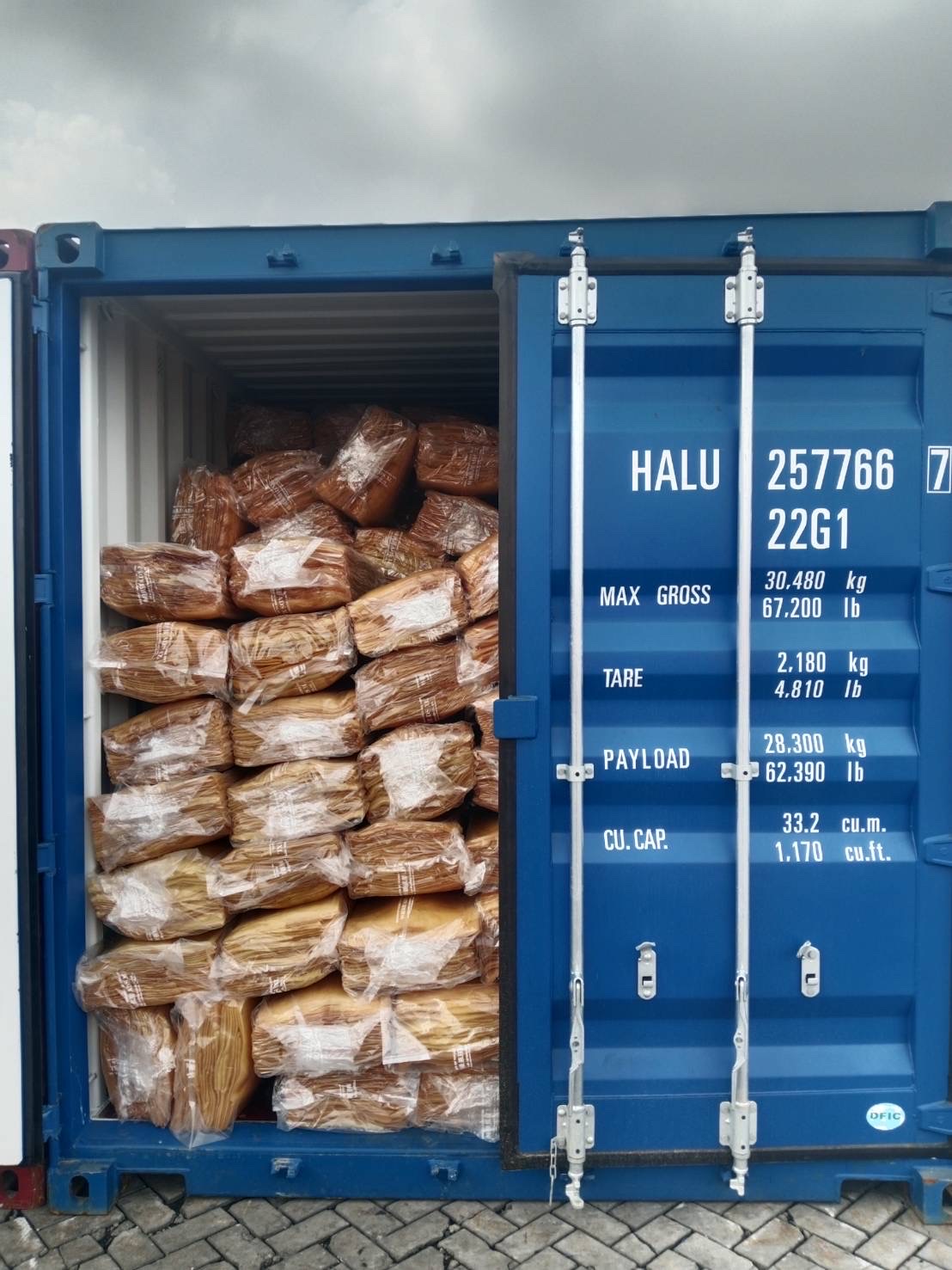 Palletized packed natural rubber bales inside shipping container